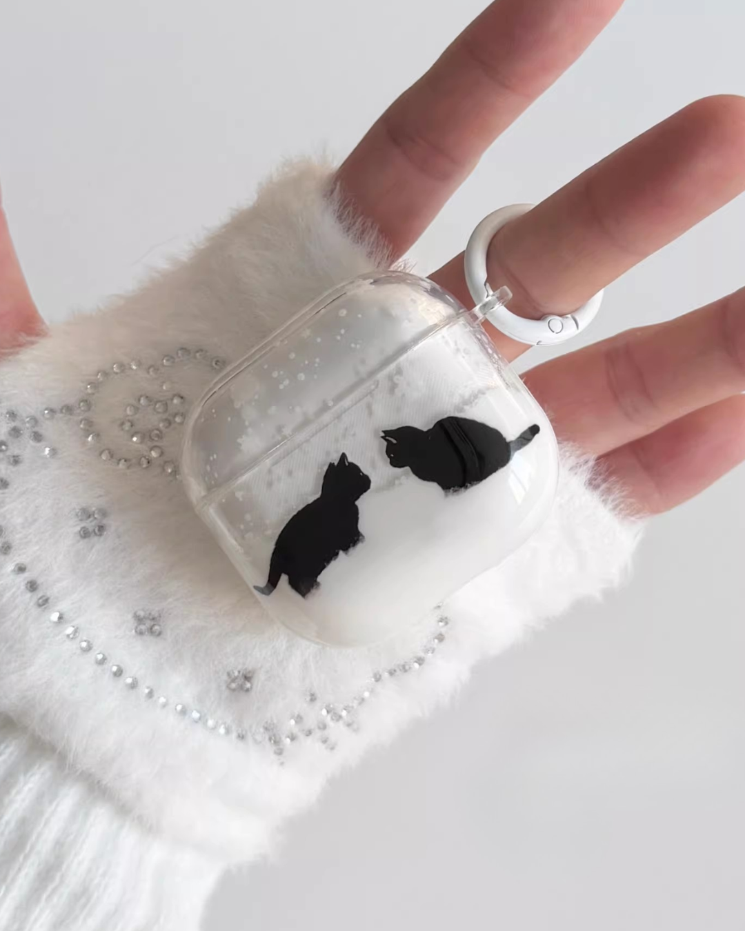 cat meeting airpods case