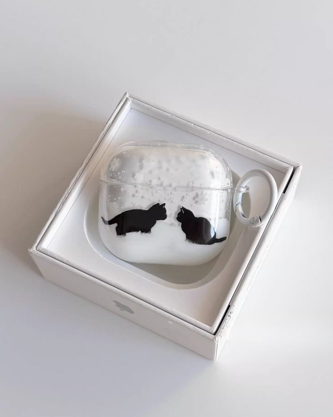 cat meeting airpods case