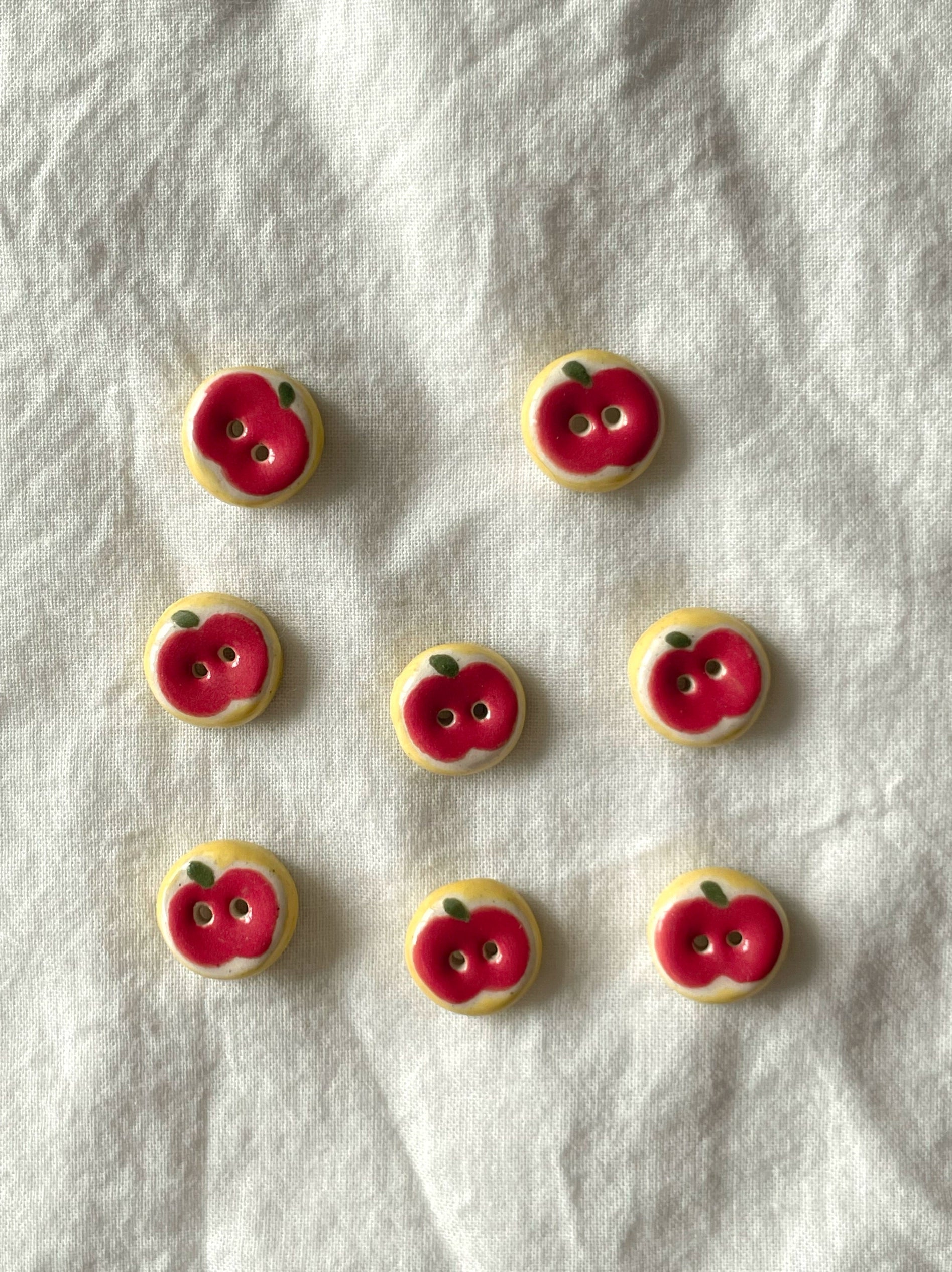 red apple buttons